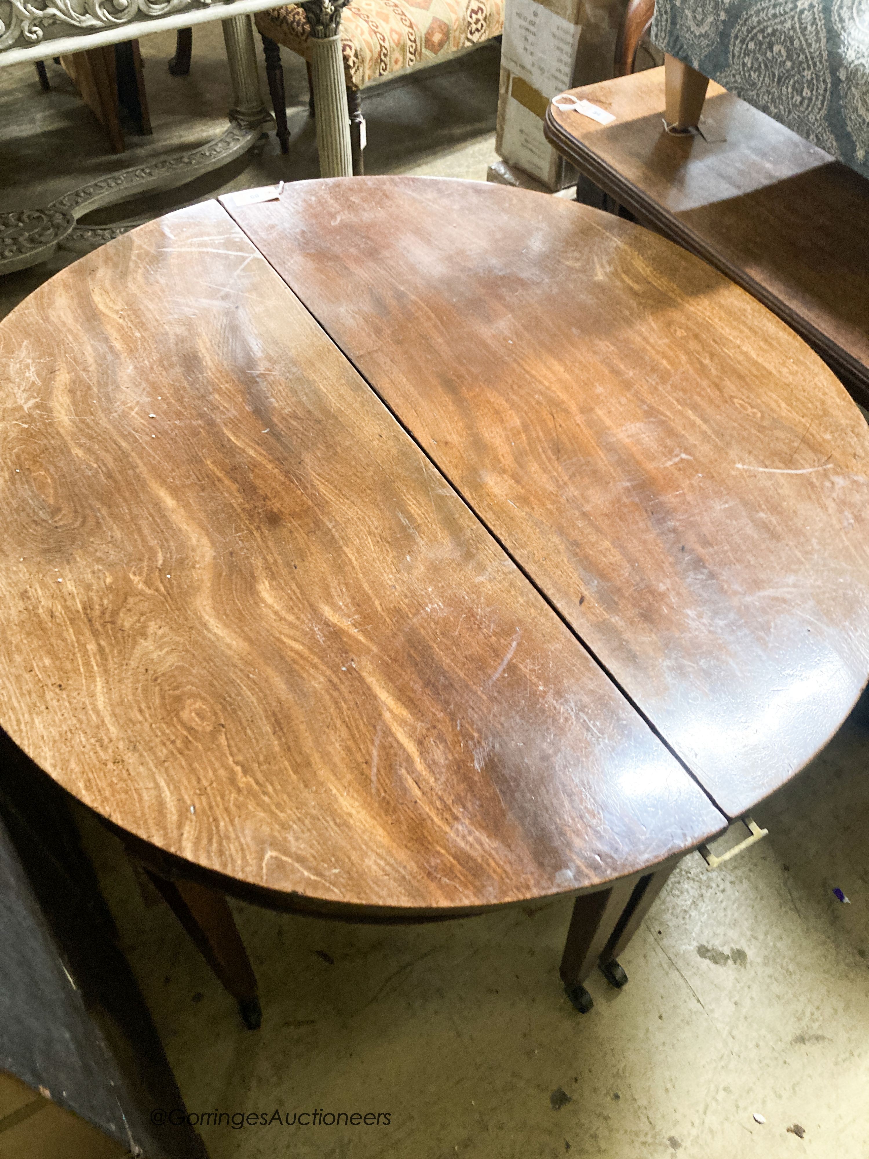 A pair of George III mahogany D shaped table sections, each measures length 120cm, depth 56cm, height 70cm